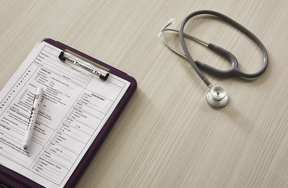 Healthcare design featuring 5784-NG Ashwood Bone woodgrain laminate desk with stethoscope