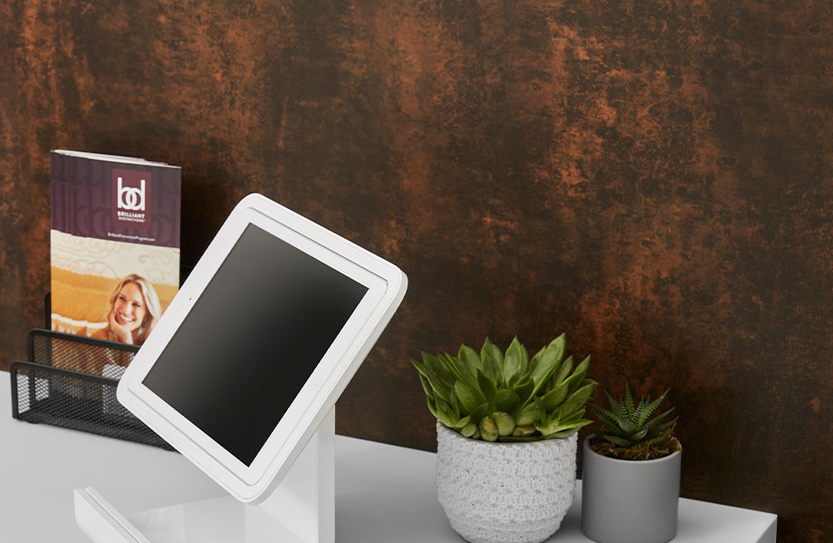 M9424 Copper Patina wall panel behind 103 Frost desktop with tablet